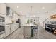 Bright open-concept kitchen boasts white cabinetry, large island, and stainless steel appliances at 907 Lake Beacon Way, Raleigh, NC 27606