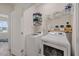 Laundry room with a front loading washer and dryer and wire storage shelves at 907 Lake Beacon Way, Raleigh, NC 27606