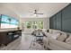 Sunlit living room featuring a comfortable sofa, stylish rug, and views of the outdoors at 907 Lake Beacon Way, Raleigh, NC 27606