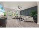 Sunlit living room featuring a comfortable sofa, stylish rug, and views of the outdoors at 907 Lake Beacon Way, Raleigh, NC 27606