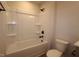 A clean and simple bathroom showcases a white bathtub with shower and matching toilet at 920 Montague Ave, Durham, NC 27703