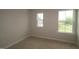 Bedroom showing beige carpet and two windows offering natural light at 920 Montague Ave, Durham, NC 27703