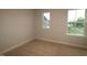 A bright bedroom with carpet and two windows create a relaxing ambiance at 920 Montague Ave, Durham, NC 27703
