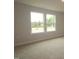 Bedroom with neutral carpet and natural light streaming through two windows at 920 Montague Ave, Durham, NC 27703