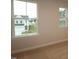 Bright bedroom features neutral walls, carpet, and windows with outside views at 920 Montague Ave, Durham, NC 27703