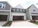 Attached garages with carriage doors provide convenient parking and complement the architectural style of the homes at 920 Montague Ave, Durham, NC 27703