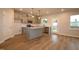 A modern kitchen with stainless steel appliances, gray cabinetry, and center island is perfect for cooking and entertaining at 920 Montague Ave, Durham, NC 27703