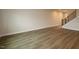An expansive living room with light wood flooring and a staircase leading to the upper level creates a warm and inviting atmosphere at 920 Montague Ave, Durham, NC 27703