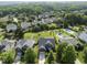 Neighborhood aerial featuring lush trees, a pool, and manicured lawns for a serene setting at 9220 Cornwell Dr, Wake Forest, NC 27587