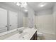 A bathroom with a single sink vanity, tile floors, and a shower and tub combination at 9220 Cornwell Dr, Wake Forest, NC 27587