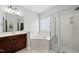 Well-lit bathroom features a soaking tub, glass shower, and vanity with ample counter space at 9220 Cornwell Dr, Wake Forest, NC 27587