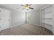 Bedroom with plush carpet, a ceiling fan, and a built-in bookshelf at 9220 Cornwell Dr, Wake Forest, NC 27587