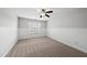 A well-lit bedroom with carpet, wainscotting, and a view of the outside at 9220 Cornwell Dr, Wake Forest, NC 27587