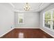 Formal dining room with crown molding, modern lighting, and large windows overlooking the yard at 9220 Cornwell Dr, Wake Forest, NC 27587