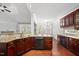 Spacious kitchen island with a dishwasher, cabinetry, and granite countertops, open to the living areas at 9220 Cornwell Dr, Wake Forest, NC 27587