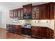 Well-equipped kitchen with stainless steel appliances, wine cooler, and rich wooden cabinets at 9220 Cornwell Dr, Wake Forest, NC 27587