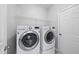 Functional laundry room with modern washer and dryer, overhead storage, and a convenient folding area at 9220 Cornwell Dr, Wake Forest, NC 27587