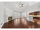 Bright living room features hardwood floors, fireplace, and opens to the kitchen and backyard patio at 9220 Cornwell Dr, Wake Forest, NC 27587