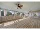 Large screened patio with wood floors and multiple ceiling fans at 9220 Cornwell Dr, Wake Forest, NC 27587