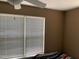 Bedroom featuring a window with blinds, a ceiling fan, and neutral-toned walls at 929 Morreene Rd # B-24, Durham, NC 27705
