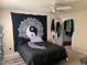 Bedroom with dark colored bedding, carpeted floors, ceiling fan, and natural light at 929 Morreene Rd # C-14, Durham, NC 27705