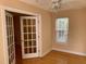 Office space with hardwood floors, glass panel doors, a window with wood blinds and white trim at 929 Morreene Rd # C-14, Durham, NC 27705