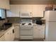 Efficient kitchen featuring white cabinetry and modern appliances at 929 Morreene Rd # D-34, Durham, NC 27705