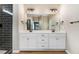 Stylish bathroom featuring double vanities, a large mirror, and contemporary lighting at 9427 Turkey Way, Middlesex, NC 27557