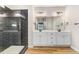 Modern bathroom featuring double vanities, a sleek glass shower and stylish fixtures at 9427 Turkey Way, Middlesex, NC 27557