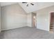 Spacious carpeted bedroom with high vaulted ceiling and a ceiling fan offers comfort and style at 9427 Turkey Way, Middlesex, NC 27557
