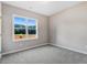 Bright carpeted bedroom with a large window offering a view of the outdoors at 9427 Turkey Way, Middlesex, NC 27557