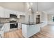 Well-equipped kitchen boasts stainless steel appliances, black granite countertops, and an island with bar seating at 9427 Turkey Way, Middlesex, NC 27557