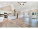 Bright, open-concept living room with vaulted ceilings and modern finishes, adjacent to the kitchen area at 9427 Turkey Way, Middlesex, NC 27557