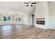 Spacious living room featuring wood floors, white brick fireplace, and trim details at 9427 Turkey Way, Middlesex, NC 27557