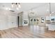 Open living space featuring a modern fireplace, neutral color palette, and kitchen with a center island at 9427 Turkey Way, Middlesex, NC 27557