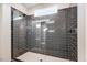 Modern shower with sleek gray tiling, glass enclosure, and elegant fixtures at 9427 Turkey Way, Middlesex, NC 27557