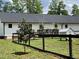 Beautiful fenced backyard with an outdoor dining area, and mature trees at 956 W Greensboro Chapel Hill Rd, Snow Camp, NC 27349