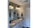 Bright bathroom featuring a double sink vanity with granite countertops for a touch of elegance and functionality at 956 W Greensboro Chapel Hill Rd, Snow Camp, NC 27349