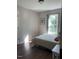 Cozy bedroom with a natural light filled window and wood-look flooring at 956 W Greensboro Chapel Hill Rd, Snow Camp, NC 27349