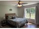 Cozy bedroom with a large window and floral bedding, creating a relaxing and comfortable retreat at 956 W Greensboro Chapel Hill Rd, Snow Camp, NC 27349