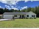 Charming single-story home featuring a two-car garage and well-manicured lawn at 956 W Greensboro Chapel Hill Rd, Snow Camp, NC 27349