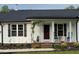 Inviting front porch with rocking chairs, offering a cozy and relaxing outdoor space at 956 W Greensboro Chapel Hill Rd, Snow Camp, NC 27349
