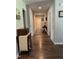 Inviting hallway featuring wood flooring, neutral paint, and tasteful decor, creating a warm and welcoming ambiance at 956 W Greensboro Chapel Hill Rd, Snow Camp, NC 27349