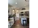 Bright kitchen with stainless steel appliances, granite countertops, and a stylish island with bar stool seating at 956 W Greensboro Chapel Hill Rd, Snow Camp, NC 27349
