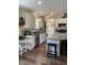 Stylish kitchen featuring white cabinets, granite countertops, and a functional island with seating at 956 W Greensboro Chapel Hill Rd, Snow Camp, NC 27349
