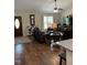 Cozy living room featuring hardwood floors, comfortable seating, and a charming front door at 956 W Greensboro Chapel Hill Rd, Snow Camp, NC 27349