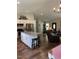 Open living area with a kitchen island, connecting to a cozy living room with leather chairs at 956 W Greensboro Chapel Hill Rd, Snow Camp, NC 27349