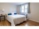 Comfortable bedroom featuring hardwood floors, a large window, and stylish decor at 979 St Marys St # G6, Raleigh, NC 27605