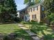 Charming two-story stone home featuring black shutters and a well-manicured front yard at 979 St Marys St # G6, Raleigh, NC 27605