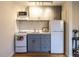 Compact kitchen with white subway tile backsplash, modern appliances, and wood flooring at 979 St Marys St # G6, Raleigh, NC 27605
